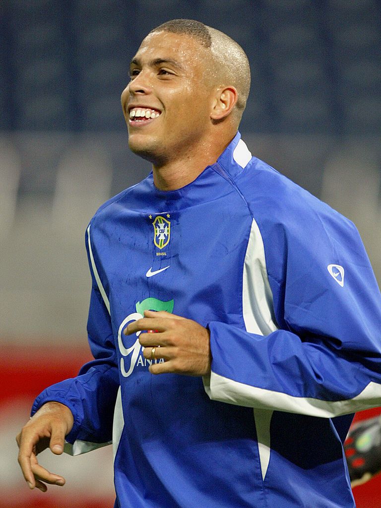 SAITAMA, JAPAN:  Brazilian soccer striker Ronaldo Nazario shows his new hair cut and smiles 24 June 2002, during a training session at Saitama World Cup stadium, in Saitama, Japan.  Ronaldo took his normal position in attack for Brazil during the practice match, easing fears he may not recover. Brazil's team will face Turkey 26 June for the semi finals of 2002 FIFA World Cup. AFP  PHOTO/Antonio SCORZA (Photo credit should read ANTONIO SCORZA/AFP via Getty Images)