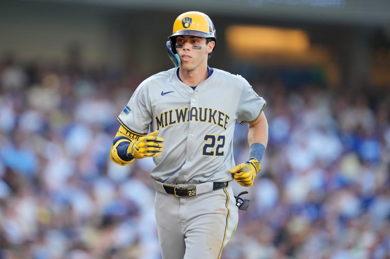 Christian Yelich (back) will undergo season-ending surgery